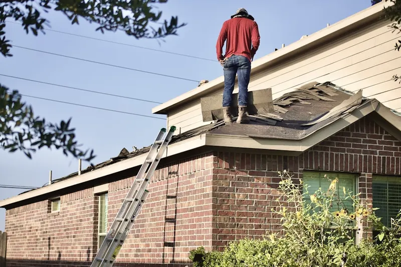 Professional roofer working on a residential roof in Thornley